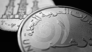 Translation: 1 one dirham United Arab Emirates. UAE coin close-up. National currency of Emirates. Black and white money