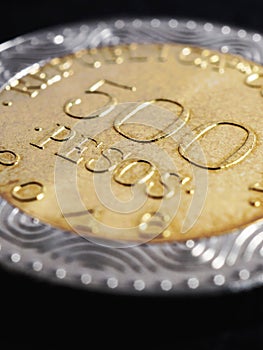 Translation: 500 Colombian pesos Republic of Colombia. Colombian coin 500 pesos. Peso of Colombia. News about economy or banking.