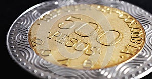 Translation: 500 Colombian pesos Republic of Colombia. Colombian coin 500 pesos. Peso of Colombia. News about economy or banking.