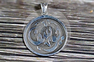Translation of Arabic text(Youssef), Arabic name on a silver pendant, Silver is a chemical element Ag