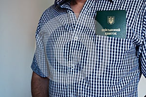 Translation: military id. Civil man in shirt with army document for rookie, veteran, soldier