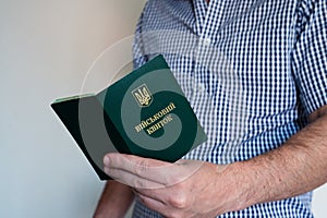 Translation: military id. Civil man in shirt with open army document for rookie, veteran, soldier