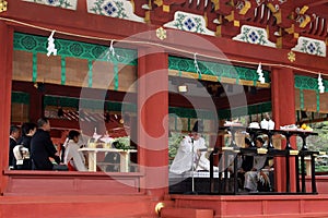 Translation: Shinto priests leading a wedding ceremony, at Tusurgaoka Shrine