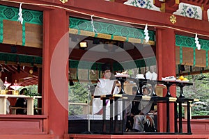 Translation: Shinto priests leading a wedding ceremony, at Tusurgaoka Shrine