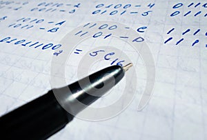 Translations of calculus systems on a notebook and black pen. creation of computer programs. work of the programmer and