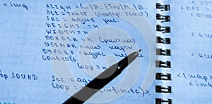 Translations of calculus systems on a notebook and black pen. creation of computer programs. work of the programmer and system