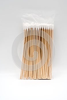 A translucent plastic pack of pasteurized cotton wool on bamboo