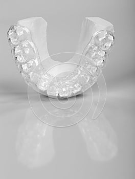 Translucent upper essix retainer on a gray background