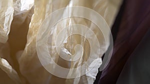 Translucent yellow chiffon curtain in bedroom, cafe or club close-up back lit