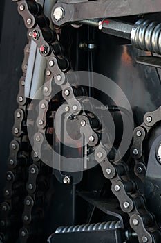 Transmission agricultural machinery. Sprockets, chain drives and springs are visible. Close-up