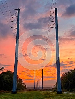 Transmission lines at dusk with colorful clouds