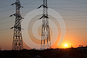Transmission power line silhouette on sunset