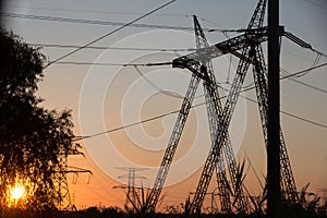 Transmission power line silhouette on sunset