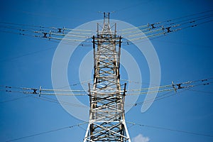 Transmission tower against blue sky