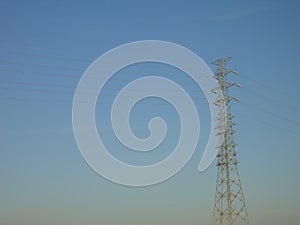 A transmission tower with blue sky