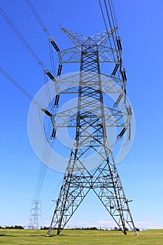 Transmission tower countryside by blue sky