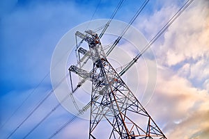A transmission tower or electricity pylon with blue sky. It is a tall structure, usually a steel lattice tower, used to support an