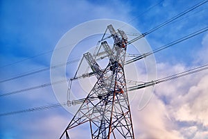 A transmission tower or electricity pylon with blue sky. It is a tall structure, usually a steel lattice tower, used to support an