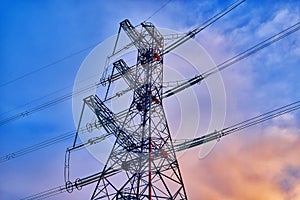 A transmission tower or electricity pylon with blue sky. It is a tall structure, usually a steel lattice tower, used to support an