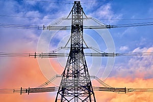 A transmission tower or electricity pylon with blue sky. It is a tall structure, usually a steel lattice tower, used to support an