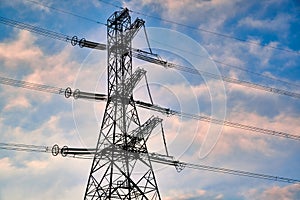 A transmission tower or electricity pylon with blue sky. It is a tall structure, usually a steel lattice tower, used to support an