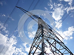 Transmission tower in front of a blue sunny sky