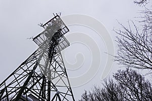 transmission tower at a mountain with gray sky