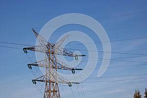 Transmission tower, or power line, in front of a clear blue sky, on a Sunny day