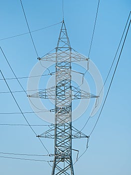 A transmission tower or power tower. High voltage tower against clear blue sky