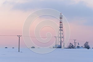 Transmission tower in winter, Telecommunications tower with cellular antenna