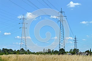 Transmission towers carrying high voltage electric power lines. Electricity pylons in the field