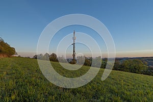 Transmitter near Vizovice town with sunrise of orange sun and fresh color air