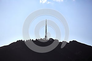 Transmitter towers on a hill, blue sky