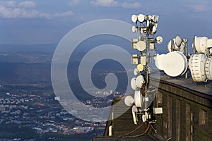 Transmitters and aerials on the telecommunication tower during sunset photo