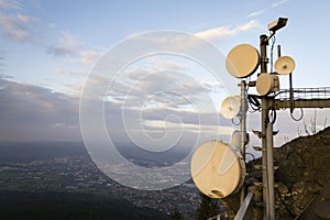 Transmitters and aerials on the telecommunication tower during sunset