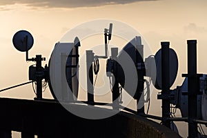 Transmitters and aerials on the telecommunication tower during sunset