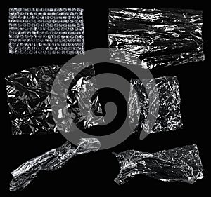 Transparencies. Transparent plastic film texture isolated on black background. Set of plastic packaging materials textures photo