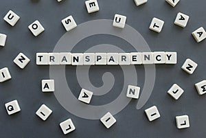 Transparency word made of square letter word on grey background.