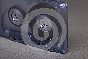 Transparent audio cassette tape orange background. Front, view