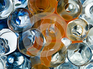 Transparent balls with orange pigment and blue ink