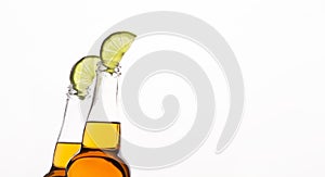 Transparent beer bottles with light drink with lime slices, cropped, isolated on white background