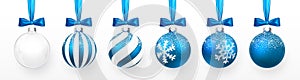 Transparent and Blue Christmas ball with snow effect and blue bow set. Xmas glass ball on white background. Holiday decoration