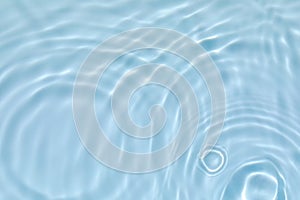 Transparent blue colored clear calm water surface texture