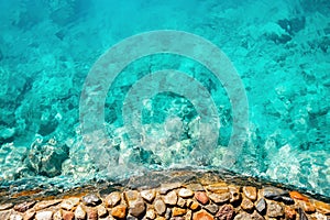 Transparent blue sea and beautiful stone shore. Background