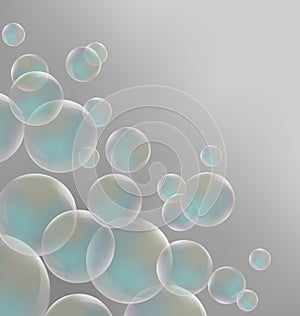 Transparent blue soap bubbles on gray