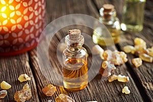 A transparent bottle of frankincense essential oil with boswellia resin