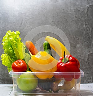 Transparent box for food donations. Open box with organic vegetables and fruits. Bank Stock of food for a car trip