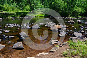 Transparent and clean river water and stones