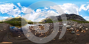 Transparent clear water of a mountain lake under a blue sky in the clouds. sand beach.Spherical panorama 360vr