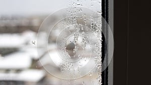 Transparent condensate in the foggy background, water dripping on clear glass. Drops of condensation close-up macro. Steam on the